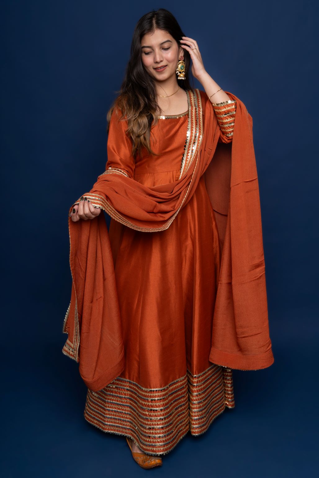 Rust Meher : Metallic orange Anarkali Suit Set.